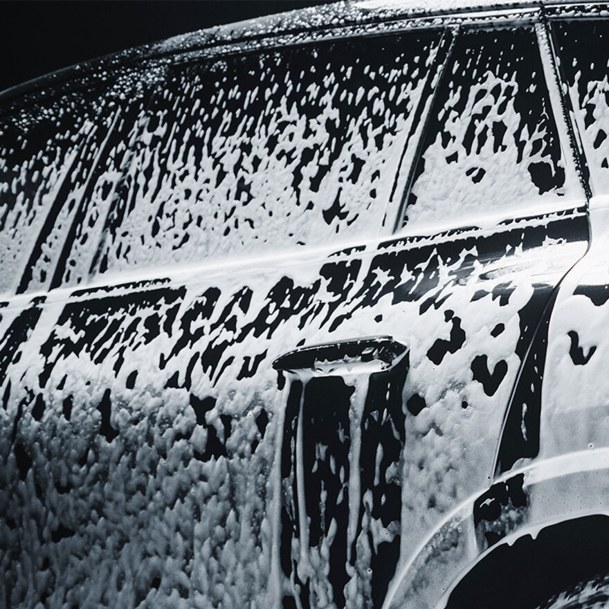 A car beeing treated with a pre-soak car wash chemical during a car wash